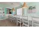 Spacious dining room with a large table, white chairs, and beachy decor at 1055 Lake Berkley Dr, Kissimmee, FL 34746