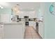 Modern kitchen with white cabinets, stainless steel appliances, and a large island at 1055 Lake Berkley Dr, Kissimmee, FL 34746