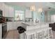 Spacious kitchen with white cabinets, granite countertops and island at 1055 Lake Berkley Dr, Kissimmee, FL 34746