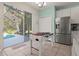 Kitchen with view of the pool and foosball table at 1055 Lake Berkley Dr, Kissimmee, FL 34746