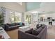 Open living room with high ceilings, and view of pool and kitchen at 1055 Lake Berkley Dr, Kissimmee, FL 34746