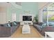 Bright living room with two grey sofas and high ceilings at 1055 Lake Berkley Dr, Kissimmee, FL 34746