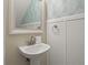 Charming powder room with pedestal sink and shiplap wainscoting at 1055 Lake Berkley Dr, Kissimmee, FL 34746