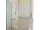 Updated shower with a frameless glass enclosure and grab bar at 1055 Lake Berkley Dr, Kissimmee, FL 34746
