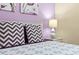 Close up of a bed with purple and gray chevron pillows at 1473 Moon Valley Dr, Davenport, FL 33896