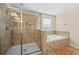 Bathroom with a large walk-in shower and a soaking tub at 1473 Moon Valley Dr, Davenport, FL 33896