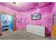 Princess-themed bedroom with a dresser and mural at 1473 Moon Valley Dr, Davenport, FL 33896