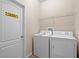 Laundry room with washer, dryer, and overhead shelving at 1473 Moon Valley Dr, Davenport, FL 33896