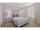 Bedroom with purple walls, white bed, and gray chevron pillows at 1473 Moon Valley Dr, Davenport, FL 33896
