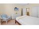 Guest bedroom with a queen bed, dresser and wicker chair at 1473 Moon Valley Dr, Davenport, FL 33896