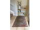 Condo entryway with a bookshelf, rug, and staircase at 413 Summit Ridge Pl # 209, Longwood, FL 32779