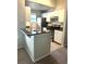 Kitchen with granite countertops, stainless steel appliances, and white cabinets at 413 Summit Ridge Pl # 209, Longwood, FL 32779