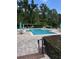 Community pool with lounge chairs and umbrellas at 413 Summit Ridge Pl # 209, Longwood, FL 32779