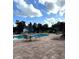 Community pool area with tables and lounge chairs at 413 Summit Ridge Pl # 209, Longwood, FL 32779