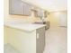 Modern kitchen with gray cabinets and white countertops at 514 Margaret Ln, Lake Wales, FL 33853