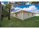 Cute yellow house with a green lawn and large tree at 514 Margaret Ln, Lake Wales, FL 33853