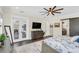 Spacious main bedroom with hardwood floors, a large TV, and access to a private balcony at 4001 Ainsley Ave, Orlando, FL 32833