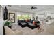 Spacious Gathering room featuring a sectional sofa, and access to the kitchen and pool at 4001 Ainsley Ave, Orlando, FL 32833