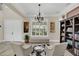 Light-filled sitting area adjacent to the entryway, featuring a built-in bookshelf at 4001 Ainsley Ave, Orlando, FL 32833