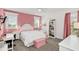 Charming bedroom with a pink color scheme and plenty of natural light at 4001 Ainsley Ave, Orlando, FL 32833