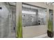 Luxurious shower with frameless glass enclosure and gray tile at 4001 Ainsley Ave, Orlando, FL 32833