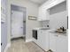 Bright laundry room with white cabinets and granite countertop at 4001 Ainsley Ave, Orlando, FL 32833