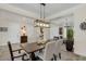 Formal dining room showcasing a wood table, chandelier, and access to the entryway at 4001 Ainsley Ave, Orlando, FL 32833