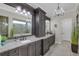 Elegant bathroom with dual vanities, a large mirror, and a chandelier at 4001 Ainsley Ave, Orlando, FL 32833