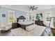 Main bedroom with hardwood floors, large windows, and comfortable seating area at 4001 Ainsley Ave, Orlando, FL 32833