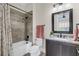 Bathroom with tub, shower, granite countertop, and dark brown cabinets at 4001 Ainsley Ave, Orlando, FL 32833