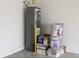 Garage corner with water heater and paint supplies at 1637 Hill Park Dr, Deltona, FL 32725