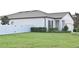 House exterior with a white fence and landscaping at 1637 Hill Park Dr, Deltona, FL 32725