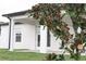 Covered patio, grassy lawn, and magnolia tree at 1637 Hill Park Dr, Deltona, FL 32725