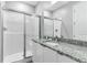 Modern bathroom with a large shower, granite countertop, and updated fixtures at 7960 Formosa Valley Pl, Kissimmee, FL 34747