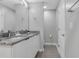Double vanity bathroom with granite countertops and a separate toilet area at 7960 Formosa Valley Pl, Kissimmee, FL 34747