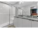 Modern bathroom with double vanity, granite countertop, and walk-in shower at 7960 Formosa Valley Pl, Kissimmee, FL 34747