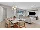 Elegant dining area with a modern light fixture and seating for six at 7960 Formosa Valley Pl, Kissimmee, FL 34747