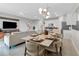 Open concept dining area with seating for six and adjacent living room at 7960 Formosa Valley Pl, Kissimmee, FL 34747