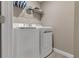 Laundry room with washer, dryer, and overhead shelving at 7960 Formosa Valley Pl, Kissimmee, FL 34747