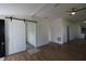 Bright hallway with sliding barn door and hardwood floors at 828 Willie Mays Pkwy, Orlando, FL 32811