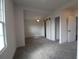Bright bedroom with gray carpet and barn door closet at 828 Willie Mays Pkwy, Orlando, FL 32811