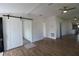 Bright hallway with sliding barn door and hardwood floors at 828 Willie Mays Pkwy, Orlando, FL 32811