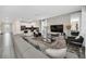 Open living area with sectional sofa and large TV, adjacent to kitchen at 730 Drop Shot Dr, Davenport, FL 33896