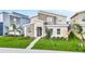 Modern two-story home with stone accents and a landscaped front yard at 730 Drop Shot Dr, Davenport, FL 33896