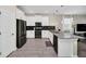 Modern kitchen with white cabinets, gray countertops, and stainless steel appliances at 730 Drop Shot Dr, Davenport, FL 33896