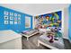 Toy Story-themed bedroom with twin beds and a vibrant blue accent wall at 730 Drop Shot Dr, Davenport, FL 33896