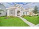 Modern home exterior with stone accents, landscaping, and walkway at 730 Drop Shot Dr, Davenport, FL 33896