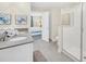 Bathroom with double sinks, gray countertops, and a walk-in shower at 730 Drop Shot Dr, Davenport, FL 33896