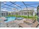 Private pool and spa with lounge chairs in a screened enclosure at 730 Drop Shot Dr, Davenport, FL 33896