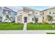 Modern two-story home with stone accents and landscaped lawn at 730 Drop Shot Dr, Davenport, FL 33896